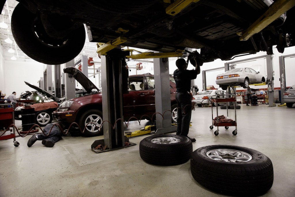 man changing brakes in a shop