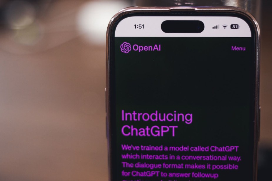 A photo of a cellphone on Open AI's Chat GPT chatbot page. This AI can help brainstorm travel, such as road trips.