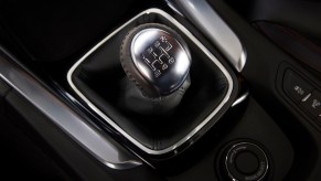 A stainless steel and black manual shifter in a Chevrolet SS.
