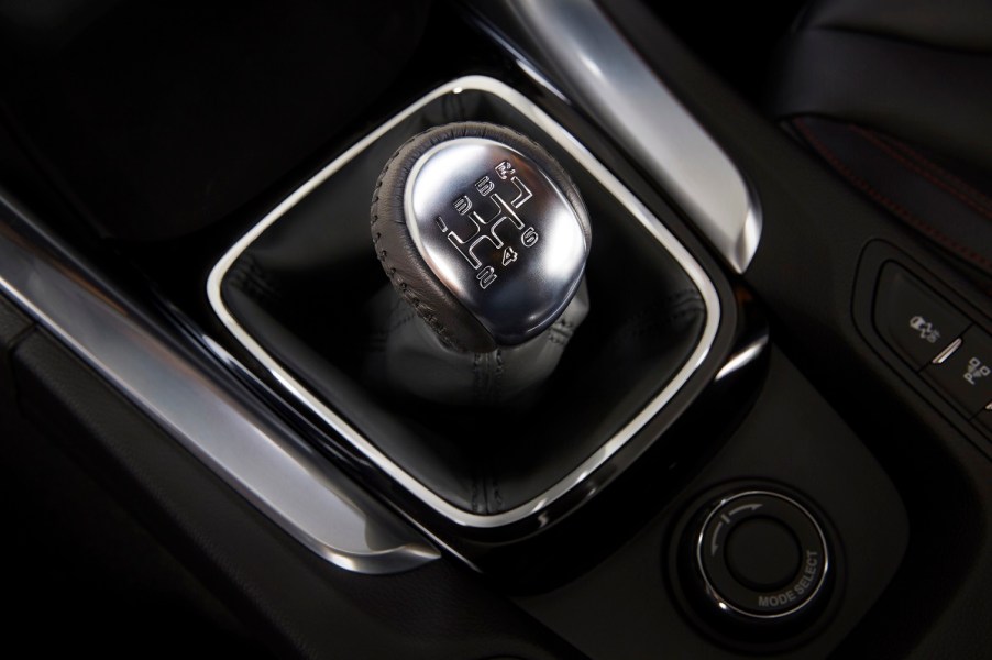 A stainless steel and black manual shifter in a Chevrolet SS.