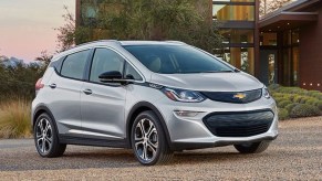 Silver Chevy Bolt EV Parked in front of a house - GM is deleting the Bolt EV and EUV in favor of the new Chevy Silverado EV and GMC Sierra EV