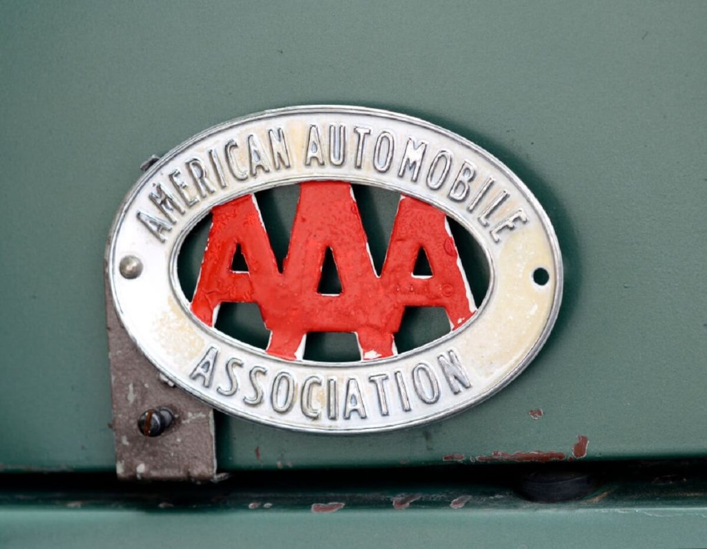 A classic AAA badge on an old truck. 