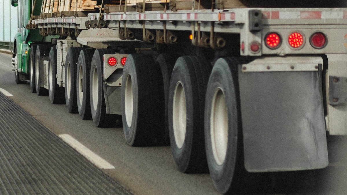 Close-up view of tires on semi-truck, showing why it has so many wheels