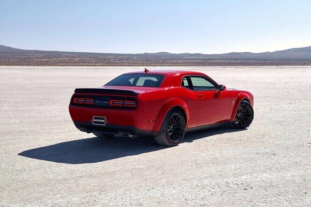 A red Dodge Challenger R/T Scat Pack shows off its widebody muscle car stance. 