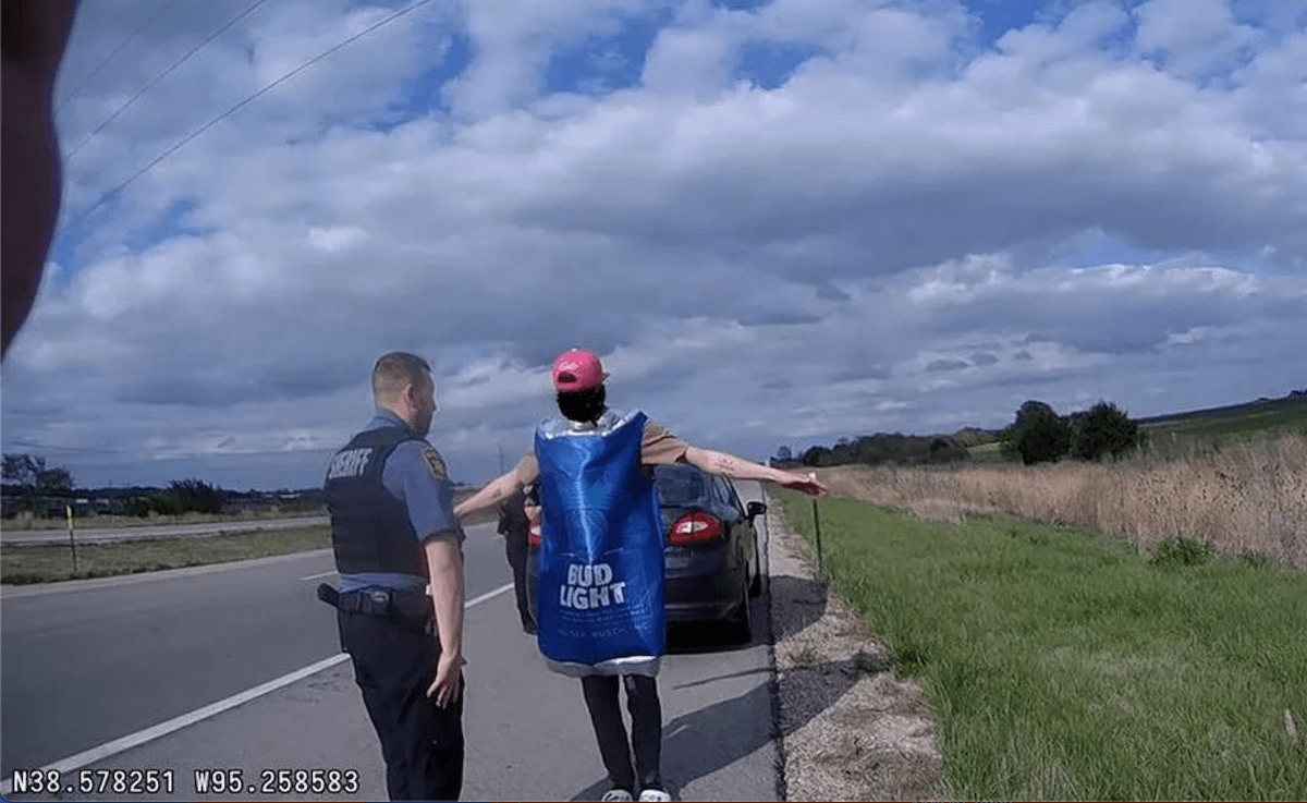 Drunk driving suspect in Bud Light costume with arms extended