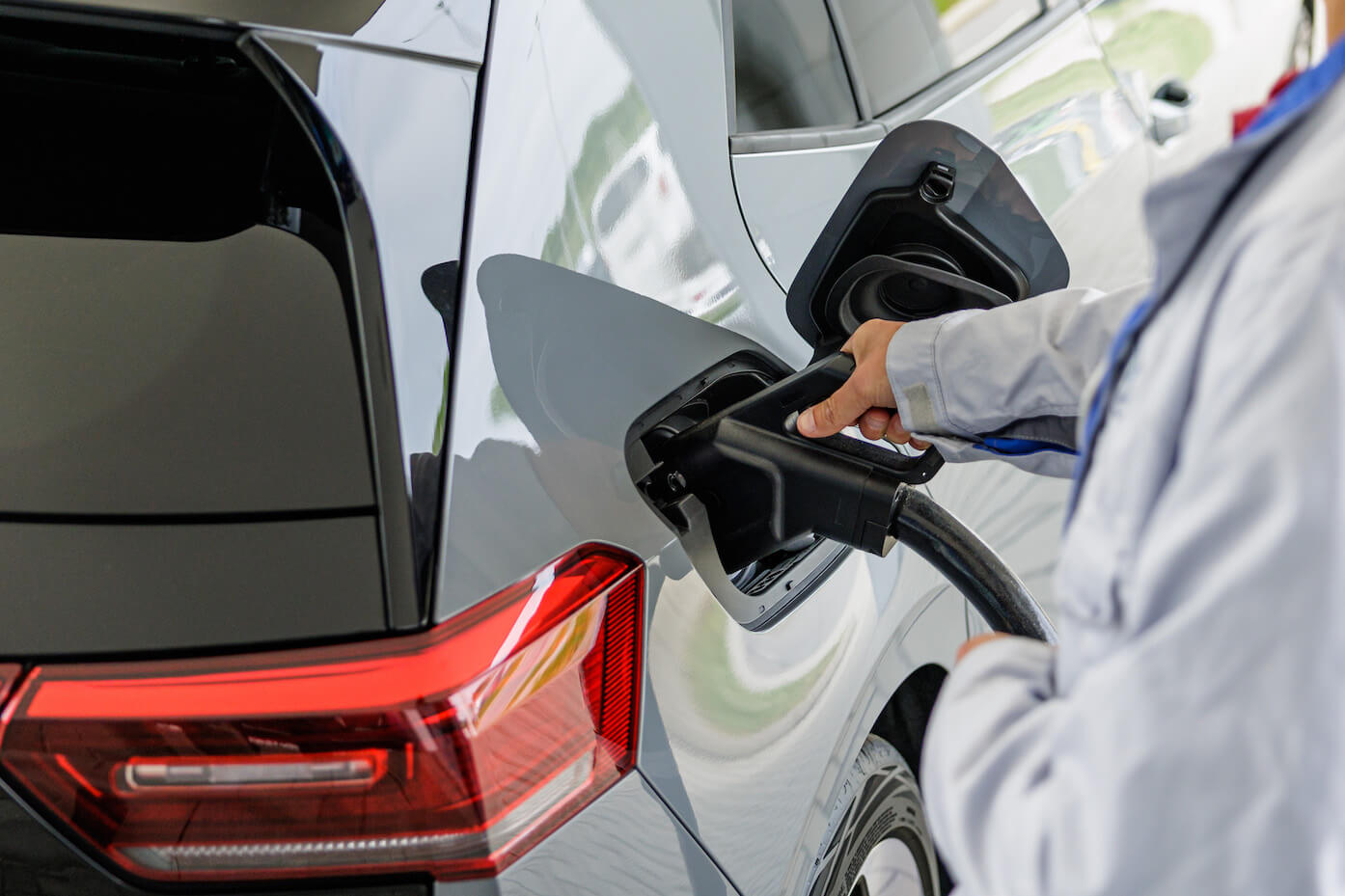 A worker demonstrates the EV charging process of Volkswagen's second generation ID.3 electric car
