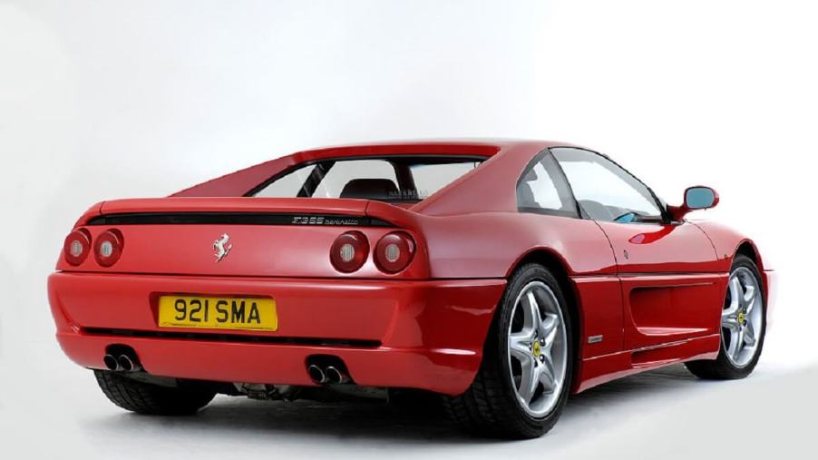 A used Ferrari F355 shows off its new number plate and rear-end styling.