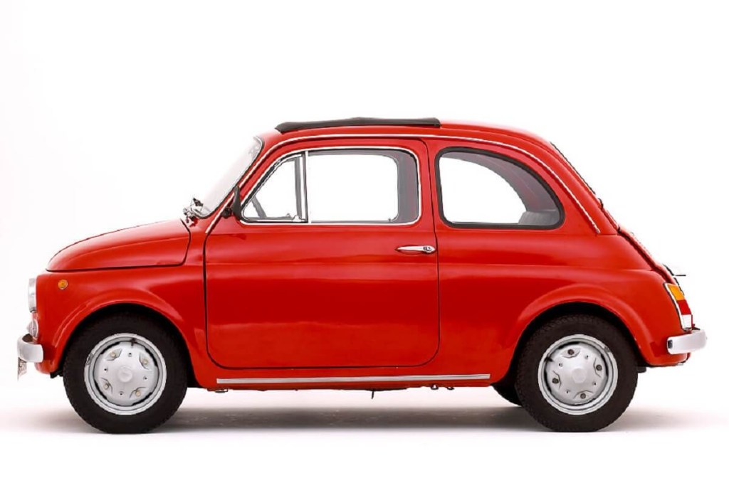 This slow classic car, a Fiat 500, shows off its short wheelbase. 