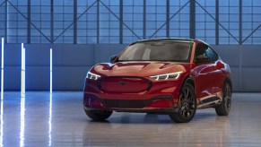 A red 2023 Ford Mustang Mach-E small electric SUV is parked.