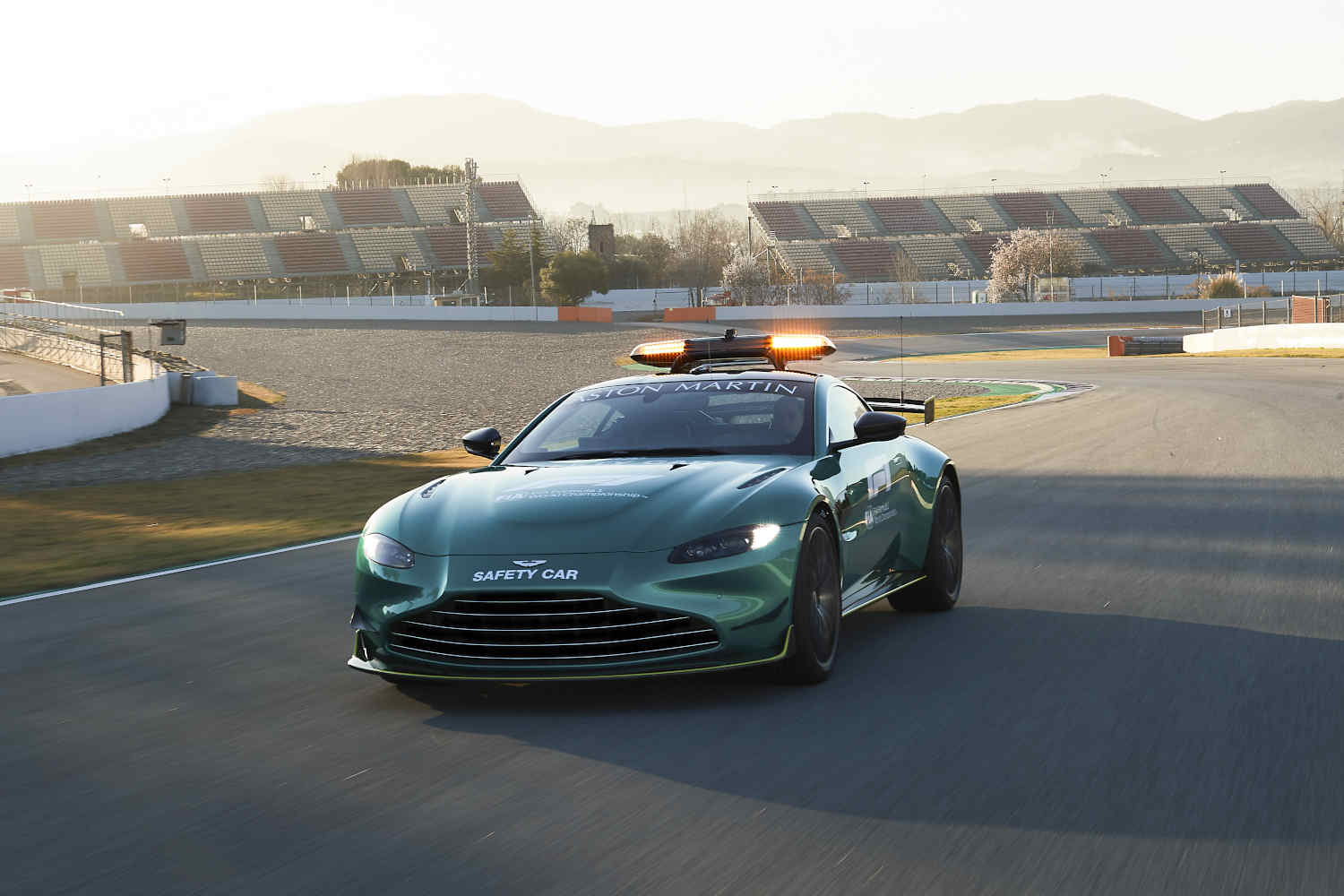 The Aston Martin Formula 1 safety car on the track, with the the Vantage F1 Edition available off-track