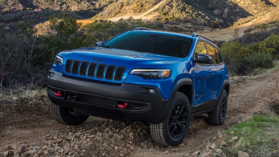 Front angle view of blue 2023 Jeep Cherokee compact SUV, most reliable Jeep, says Consumer Reports, will be killed
