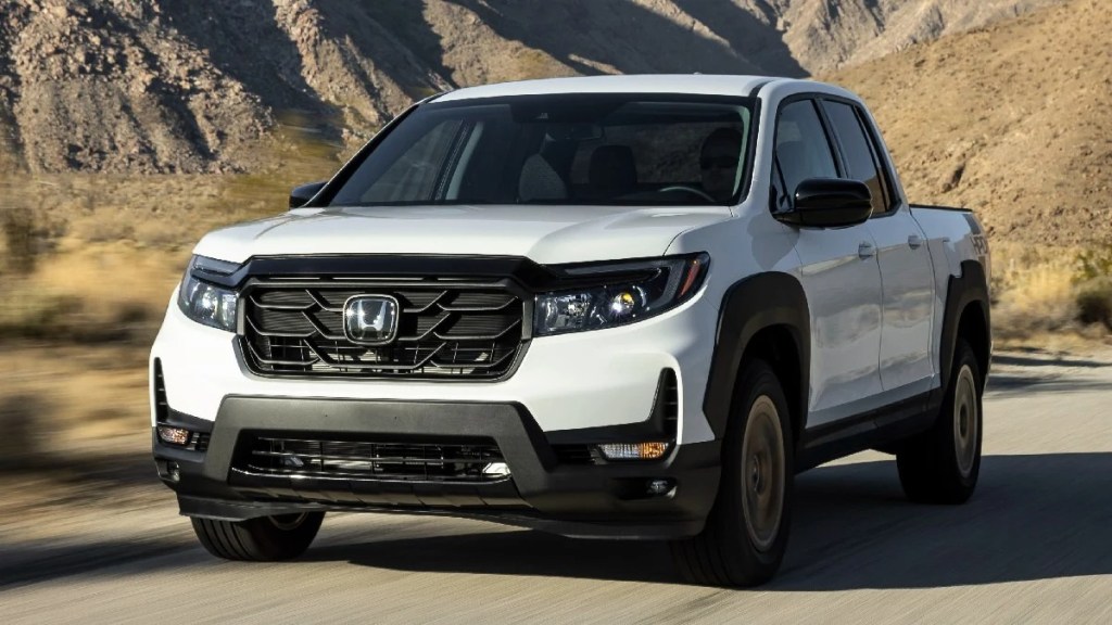 Front angle view of white 2023 Honda Ridgeline, best new midsize truck, not Toyota Tacoma or Ford Ranger