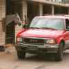 A 1995 GMC Jimmy SUV and some horses