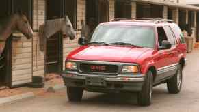 A 1995 GMC Jimmy SUV and some horses