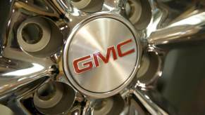 The GMC Typhoon logo on a wheel for sale in a GM showroom