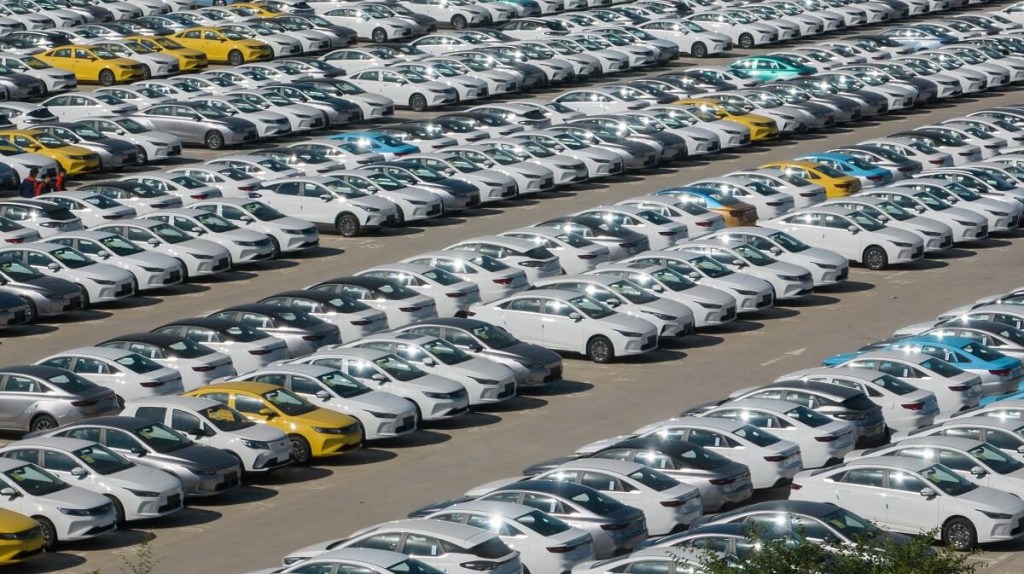 Many Chinese cars await pickup at a Geely lot. 