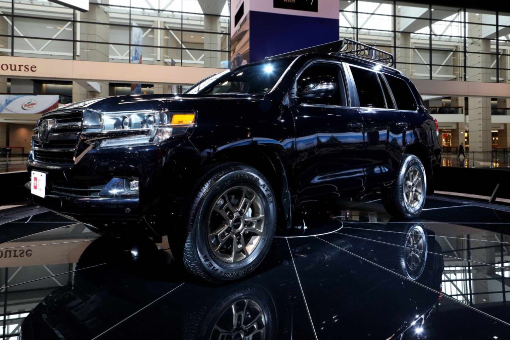 Long known as one of the best three-row off-road SUVs, the Toyota Land Cruiser sits on display at an auto show. 