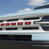 The front grille of the 2023 Ford Bronco Sport with red Bronco badging. The new 2024 Bronco may have different appearance options once it's available to order.