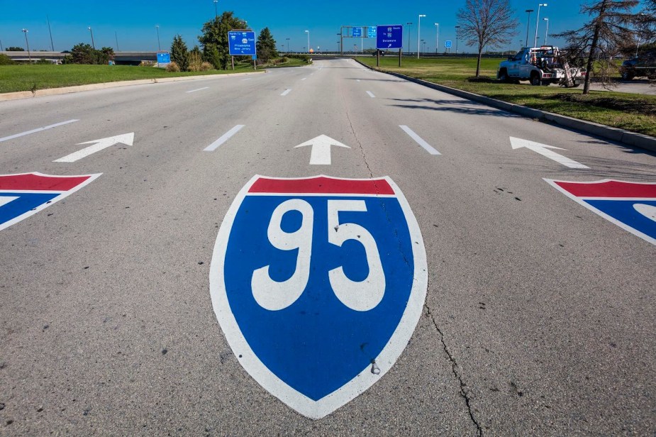 An Interstate I-95 name shield painted on the pavement of a divided highway.
