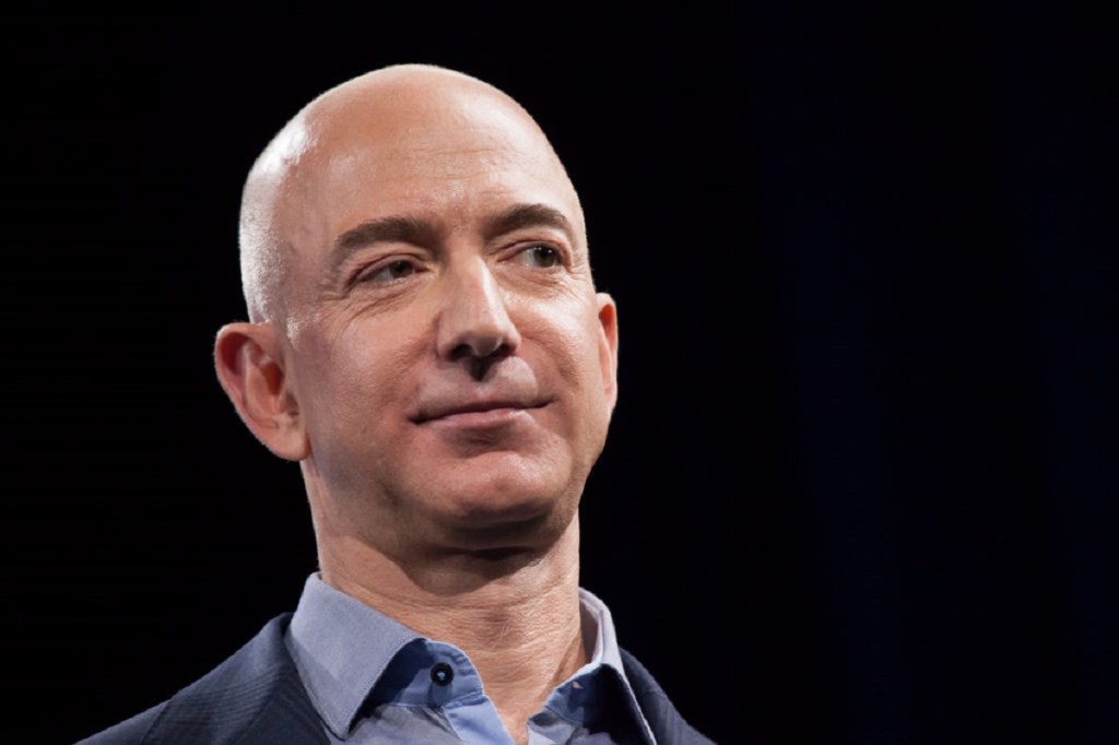 Jeff Bezos, billionaire and CEO of Amazon, smirks at an event.
