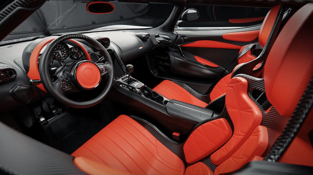 A black and orange Koenigsegg CC850 Interior shot from the drivers side of the car