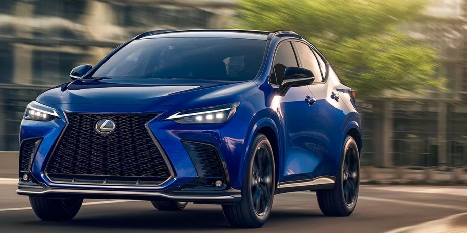 A blue 2023 Lexus NX small luxury SUV is driving on the road. 