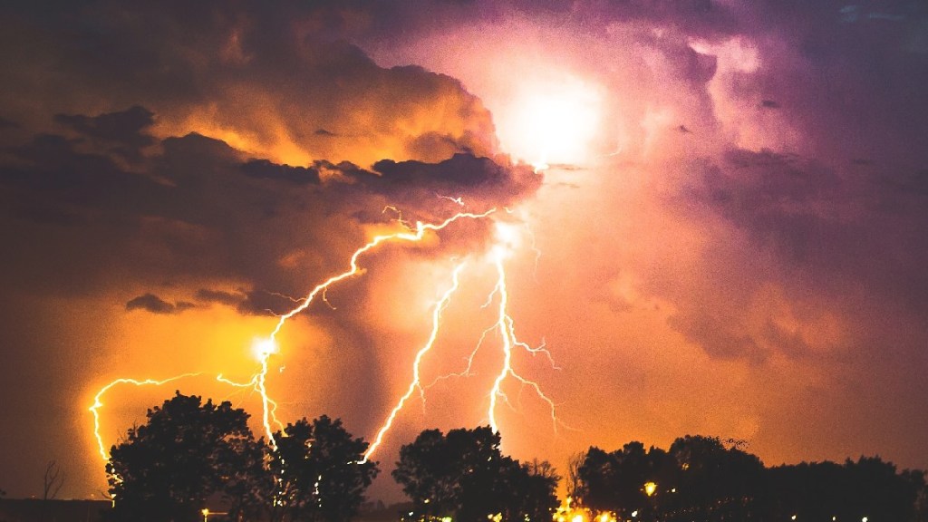 Lightning strike over trees, showing air-gen device in car that harvests energy from air
