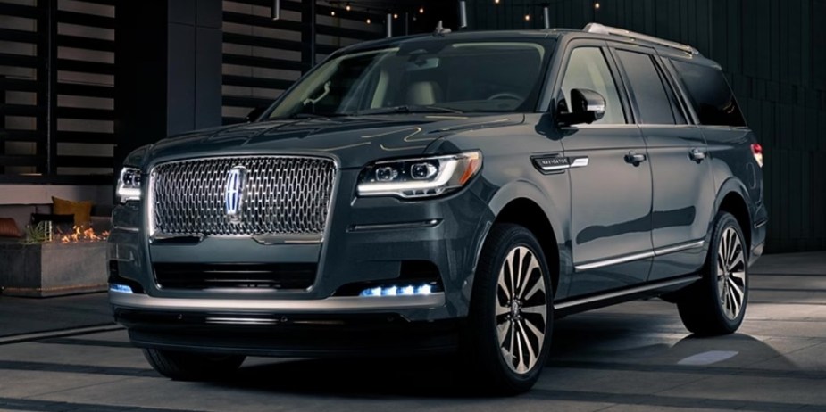 A blue 2023 Lincoln Navigator luxury full-size SUV is parked. 