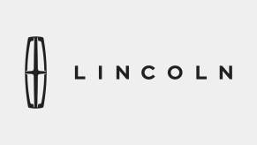 Black text of the Lincoln luxury car brand logo on a gray background