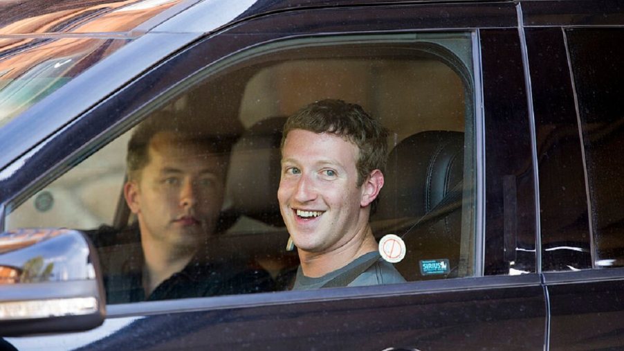 Billionaire Mark Zuckerberg smiles in a car.