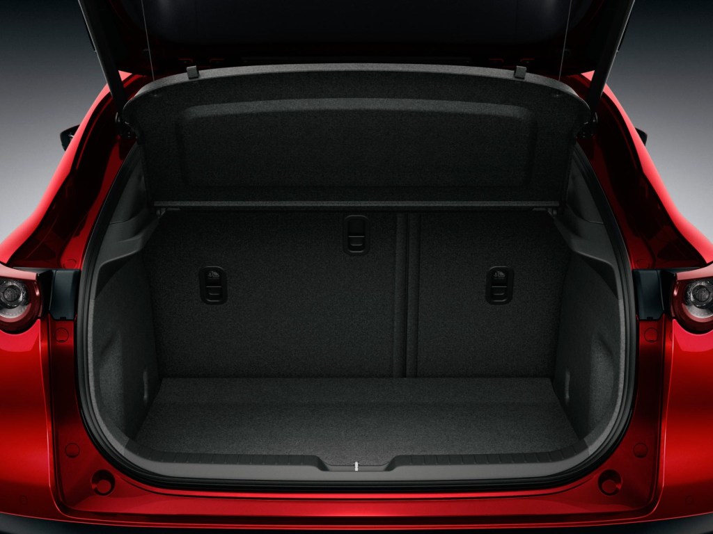 Image of the lifted rear hatch and rear cargo space of a Mazda CX-30.