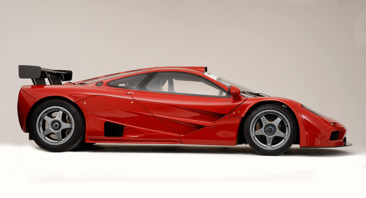 A red McLaren F1 GTR race car in a studio