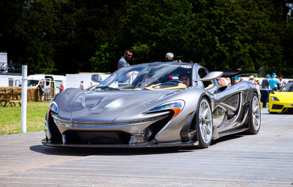 A silver McLaren P1 HDK parked at a car show