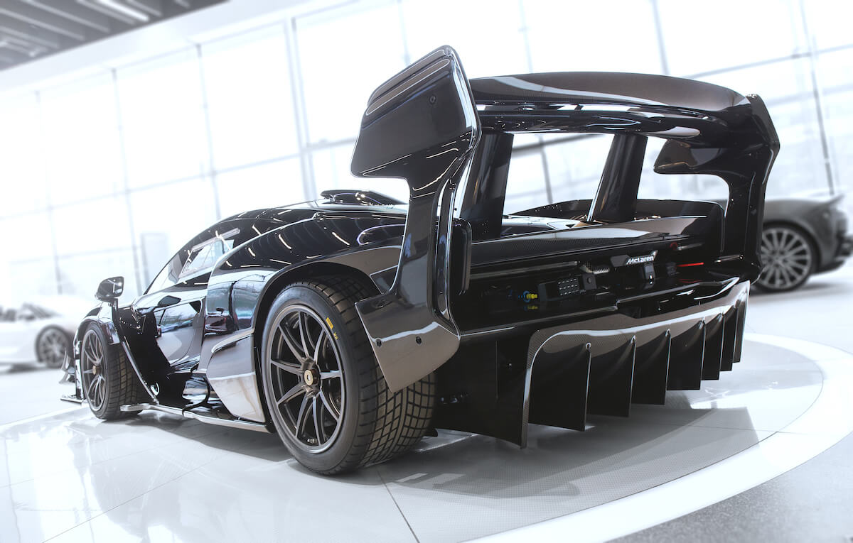 A black McLaren Senna GTR parked in an exotic car showroom