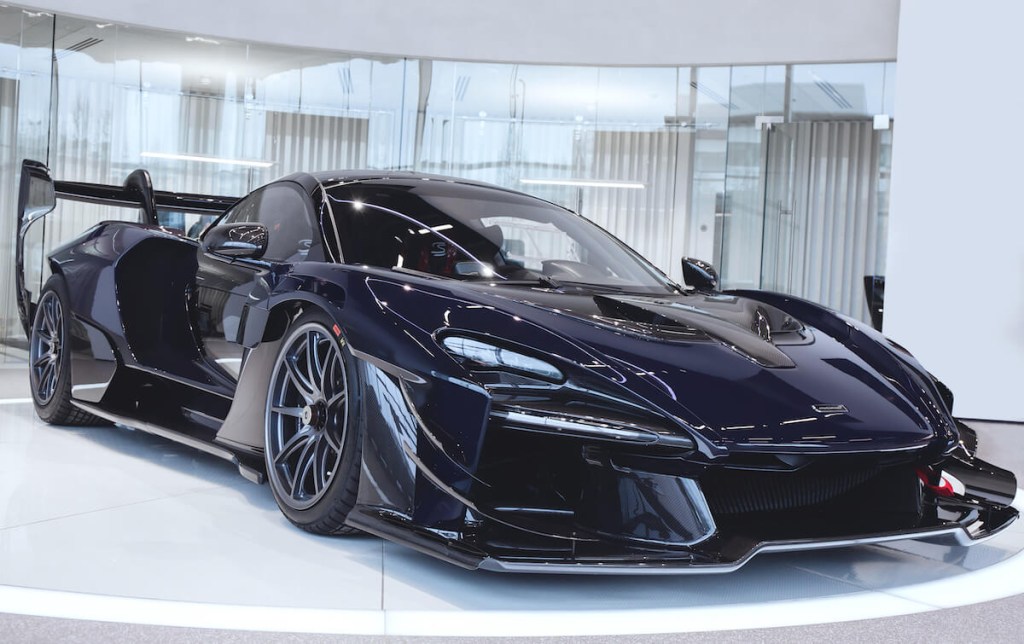 A black McLaren Senna GTR parked in a showroom
