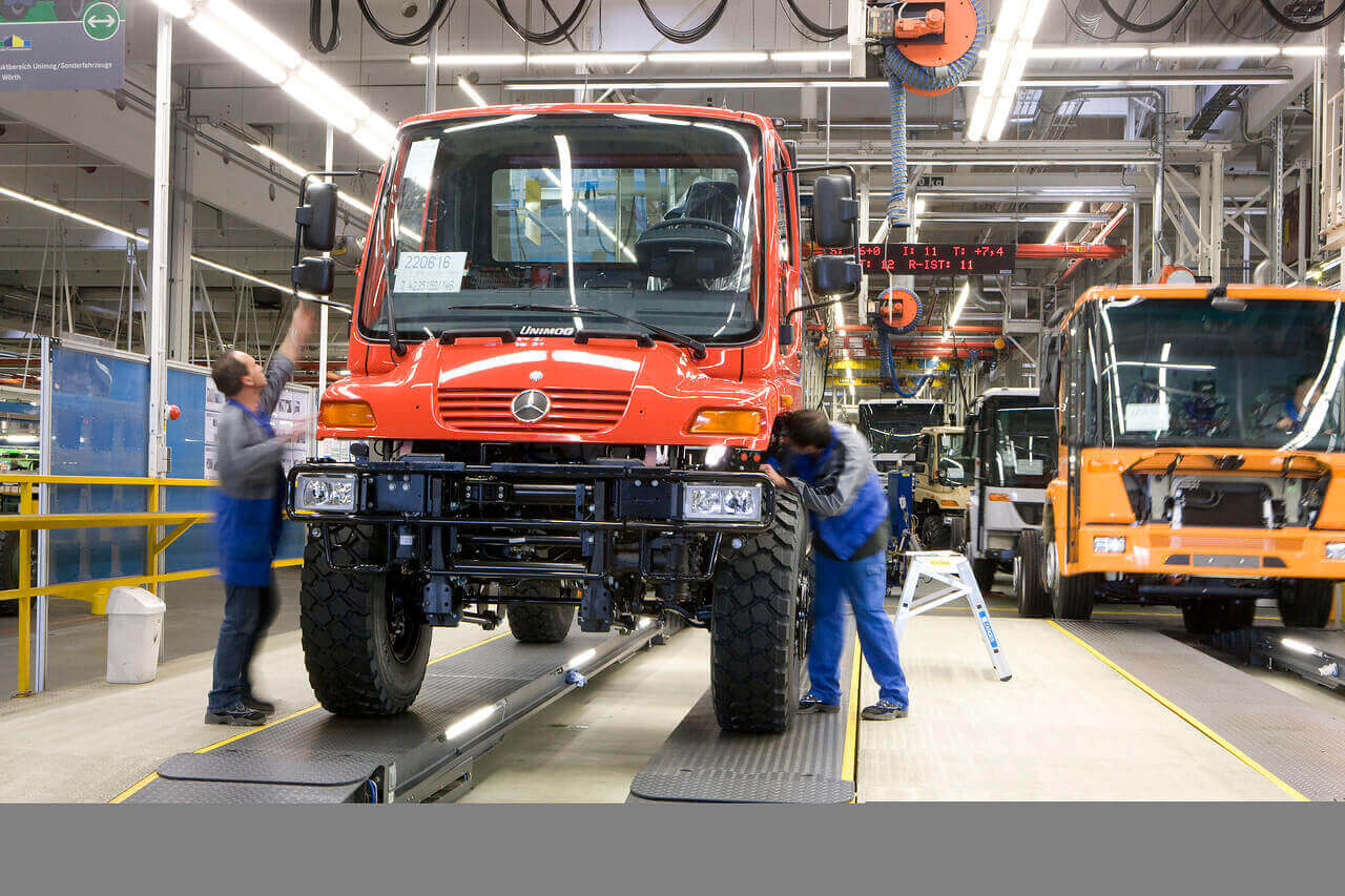 An orange Mercedes-Benz Unimog produced at Daimler in the factory.