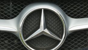 A Mercedes logo on the front of a grille.