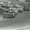 A black and white photo of a Nissan Skyline GT on a racetrack, which is powered by a Gloria V6 engine