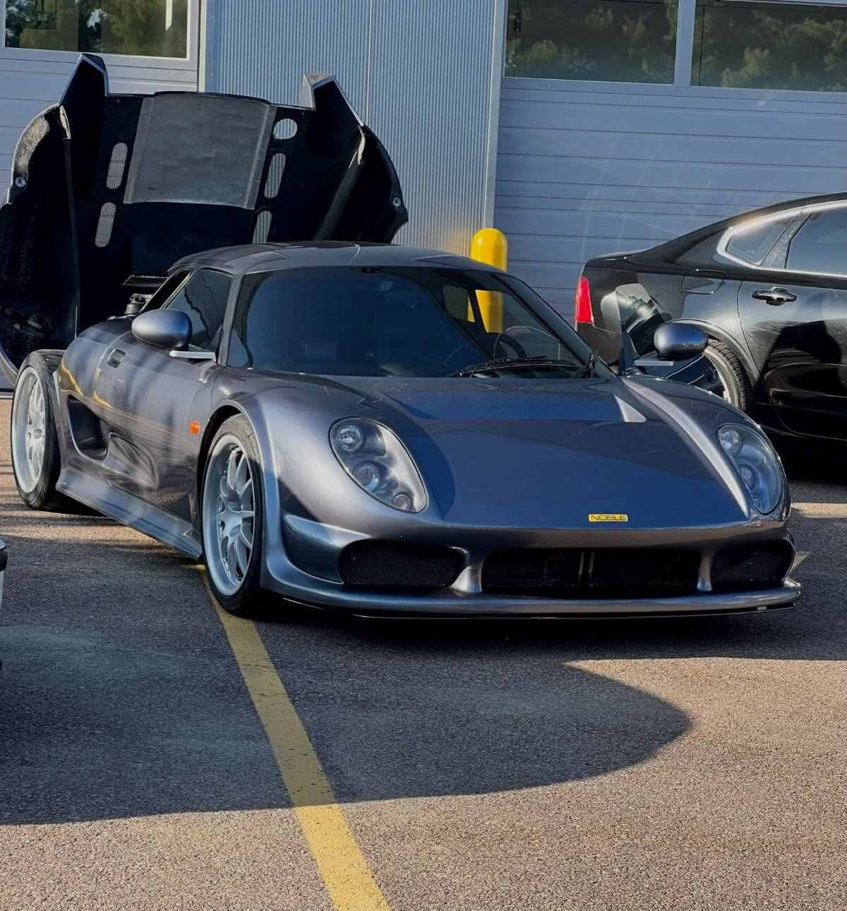 Noble M12 parked with its engine cover open