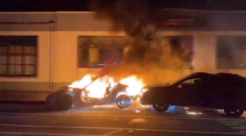 Oakland street takeover ends in burning Nissan 370Z getting rammed by a Subaru Outback. 