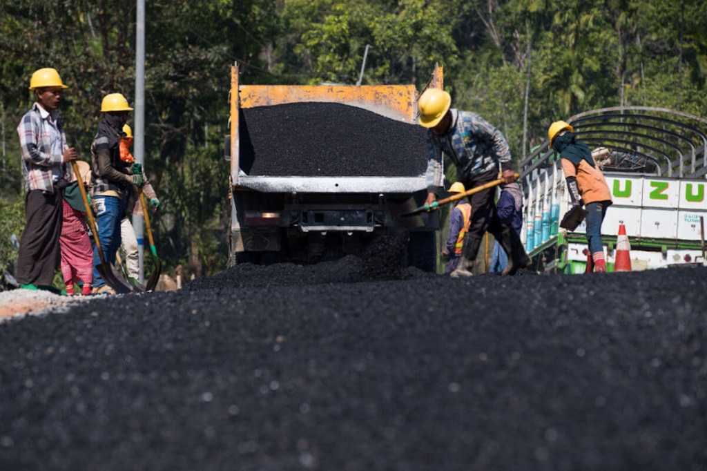 Workers shoveling asphalt in Florida