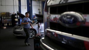 A service technician prepares to do car maintenance not covered by warranty at a Pep Boys Company auto repair and service center in Clarksville, Indiana