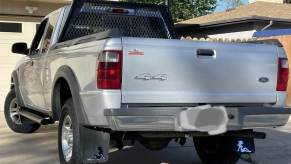 A Ford pickup truck with the silhouette of a girl visible on its mudflaps.