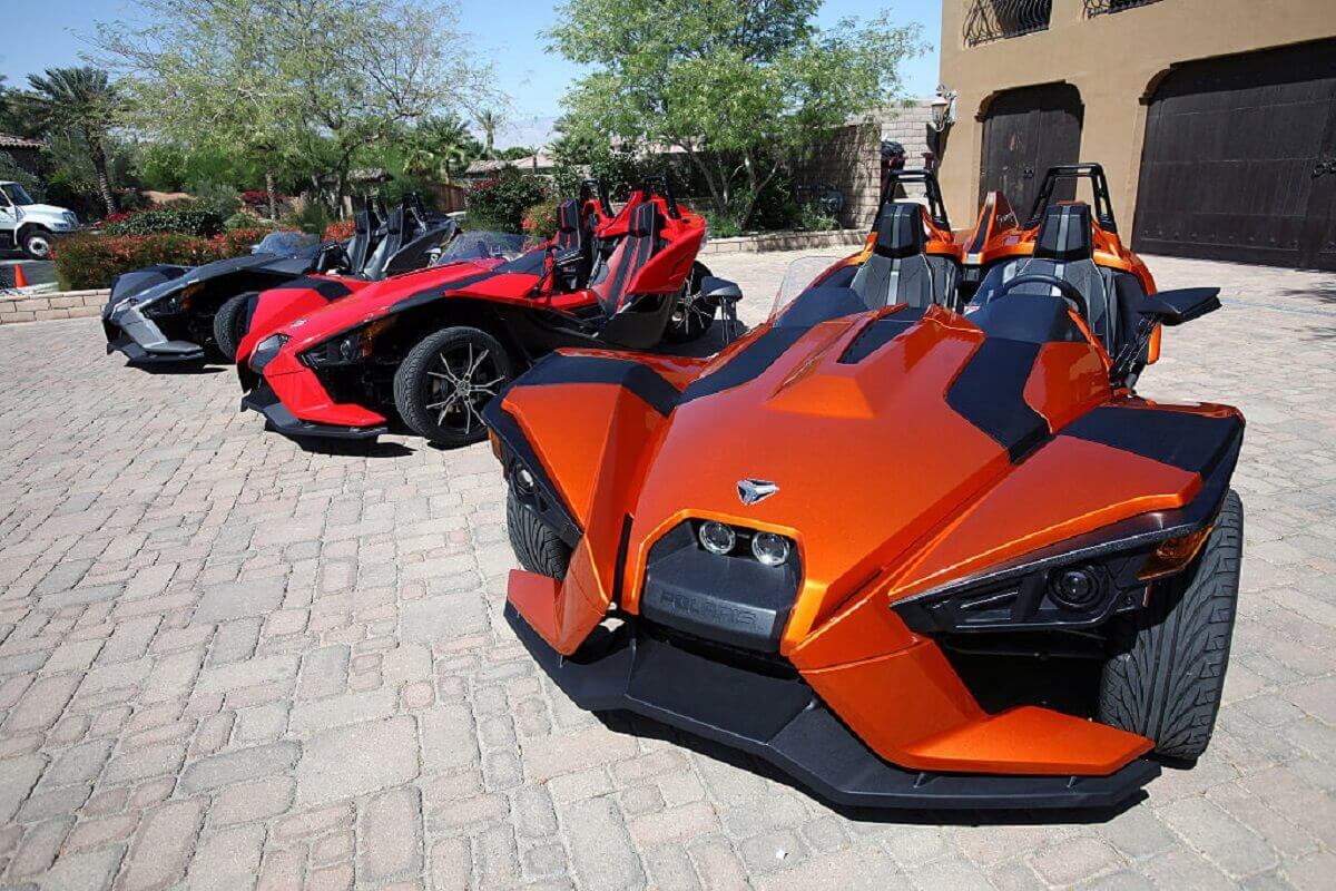 A series of Polaris Slingshot three-wheelers show off their small car size and motorcycle-inspired open cockpits.