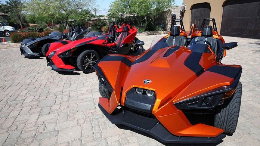 A series of Polaris Slingshot three-wheelers show off their small car size and motorcycle-inspired open cockpits.