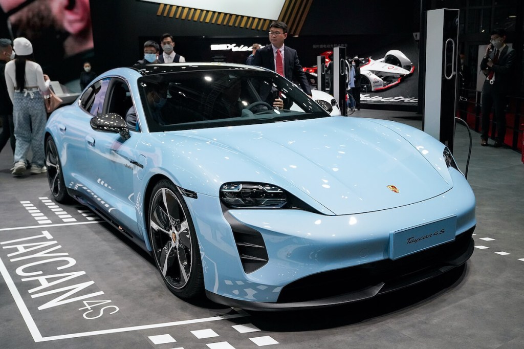 A blue Porsche Taycan at an auto show