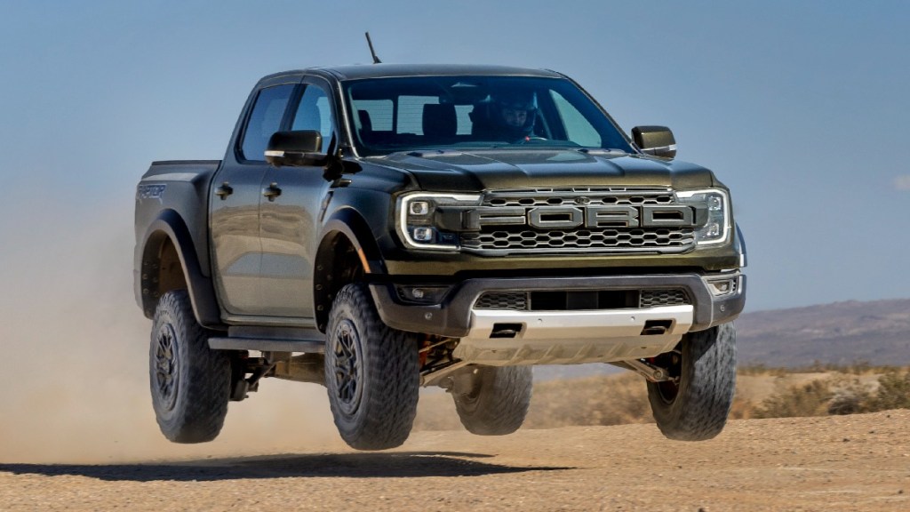 Redesigned 2024 Ford Ranger Raptor midsize pickup truck jumping in the air