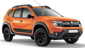 An orange Renault Duster Dakar off-road crossover SUV against a white backdrop.