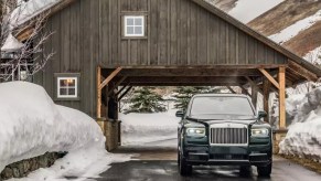 A black 2023 Rolls Royce Cullinan SUV is parked.
