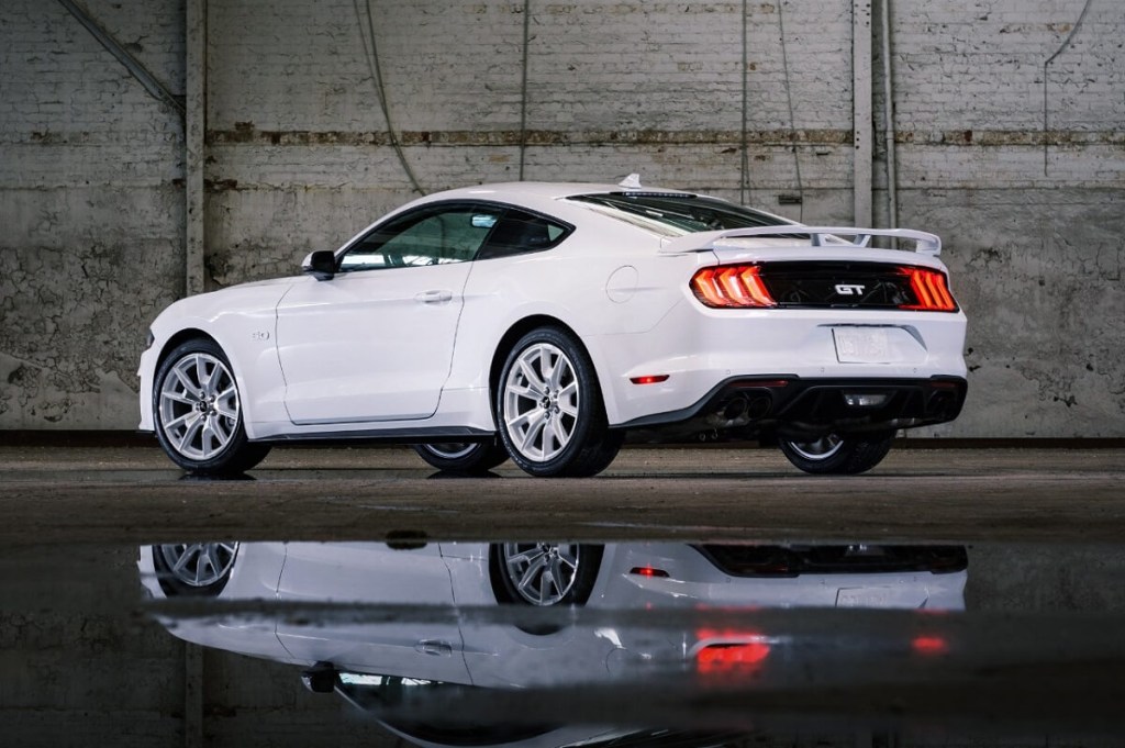 An Ice White 2023 Ford Mustang GT parks in a hangar.